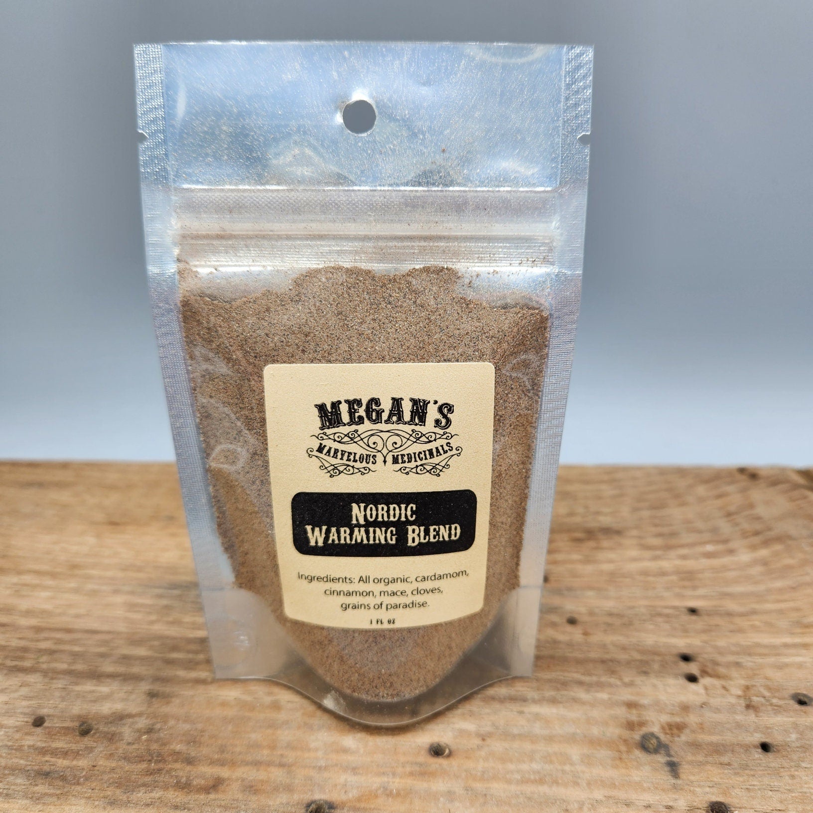 Megan's Nordic Warming Blend package on a wooden surface with a gray background